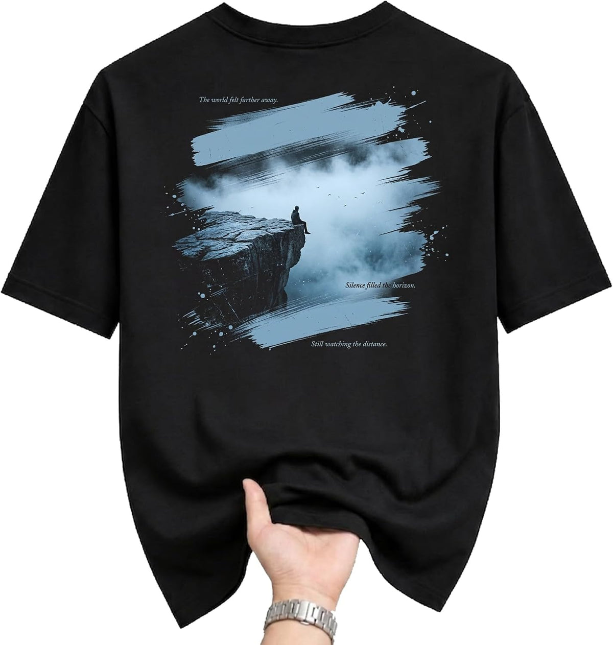 Graphic Tee Unisex Black T-Shirt Featuring Atmospheric Lone Figure Sitting on a Cliffside Design